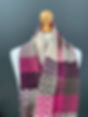 pink, burgundy and beige scarf wrapped around models shoulders