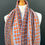 Thumbnail: orange and blue merino intricately patterned woven scarf on a mannequin