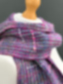Purple and pink hand-spun textured merino wool scarf draped on a mannequin, showing the colour variation and surface texture