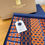 Thumbnail: woven intricately patterned merino scarf in a brown gold embossed gift box