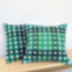 Pair of green and turquoise geometric handwoven merino lambswool cushions, made by Emma Baker in Wiltshire