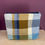 Thumbnail: handwoven blue and brass coloured make up bag