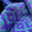 Thumbnail: close up of a handwoven purple, lilac and teal merino cowl scarf with a mosaic type pattern