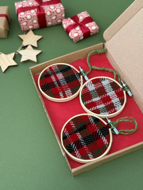 Thumbnail: three handwoven emma baker christmas bauble decorations in a gift box