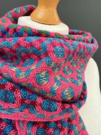 Thumbnail: close up view of a handwoven pale pink and blue merino scarf