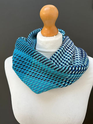 a patterned teal and navy blue twill snood scarf