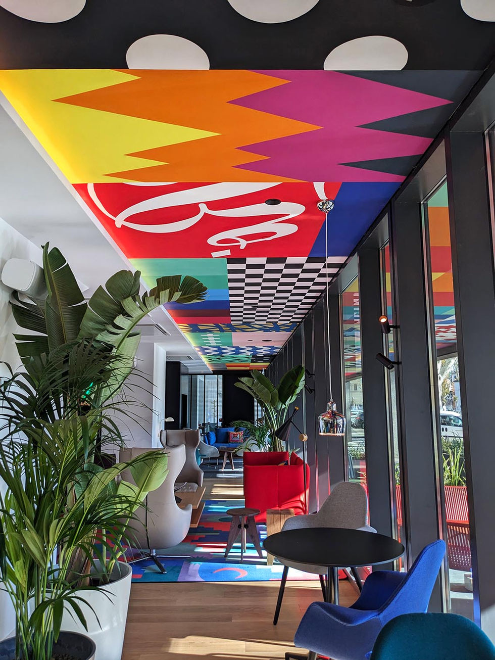 LOOK UP – Hand-painted ceiling installation at CitizenM, Isola Tiberina, Rome, 2023, with technicolor pixels and patchwork