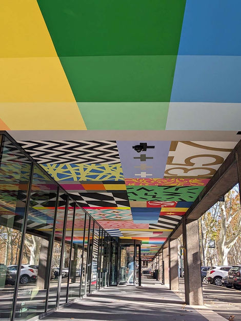 Urban art intervention under the portico: hand-painted outdoor ceiling, Isola Tiberina.
