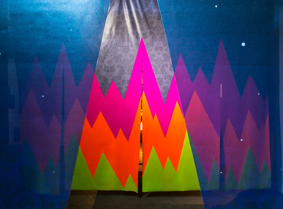 Close-up detail of a fluorescent geometric panel from UNO's /OUTSIDE IN installation.