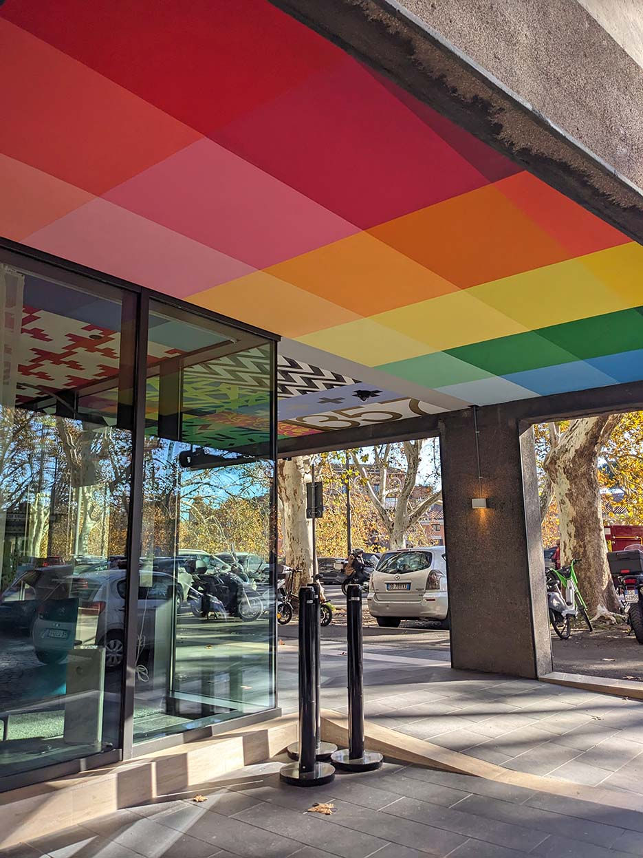 LOOK UP – Hand-painted ceiling installation at CitizenM, Isola Tiberina, Rome, 2023, with technicolor pixels and patchwork