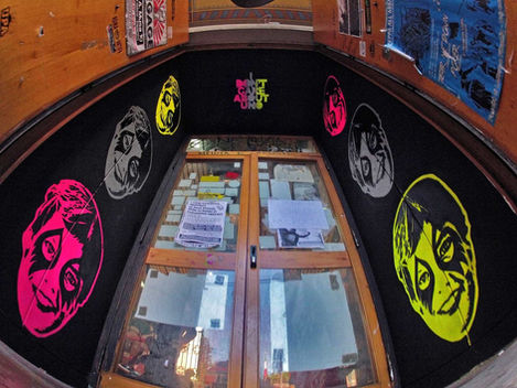 Street art installation Rome. Repetition of Kinder Günter Face stencil in neon magenta and yellow. Site-specific work by UNO.