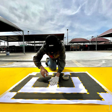Artist at work for a site-specific artwork located on a large rooftop space in Rome (casilino sky park). The piece consists