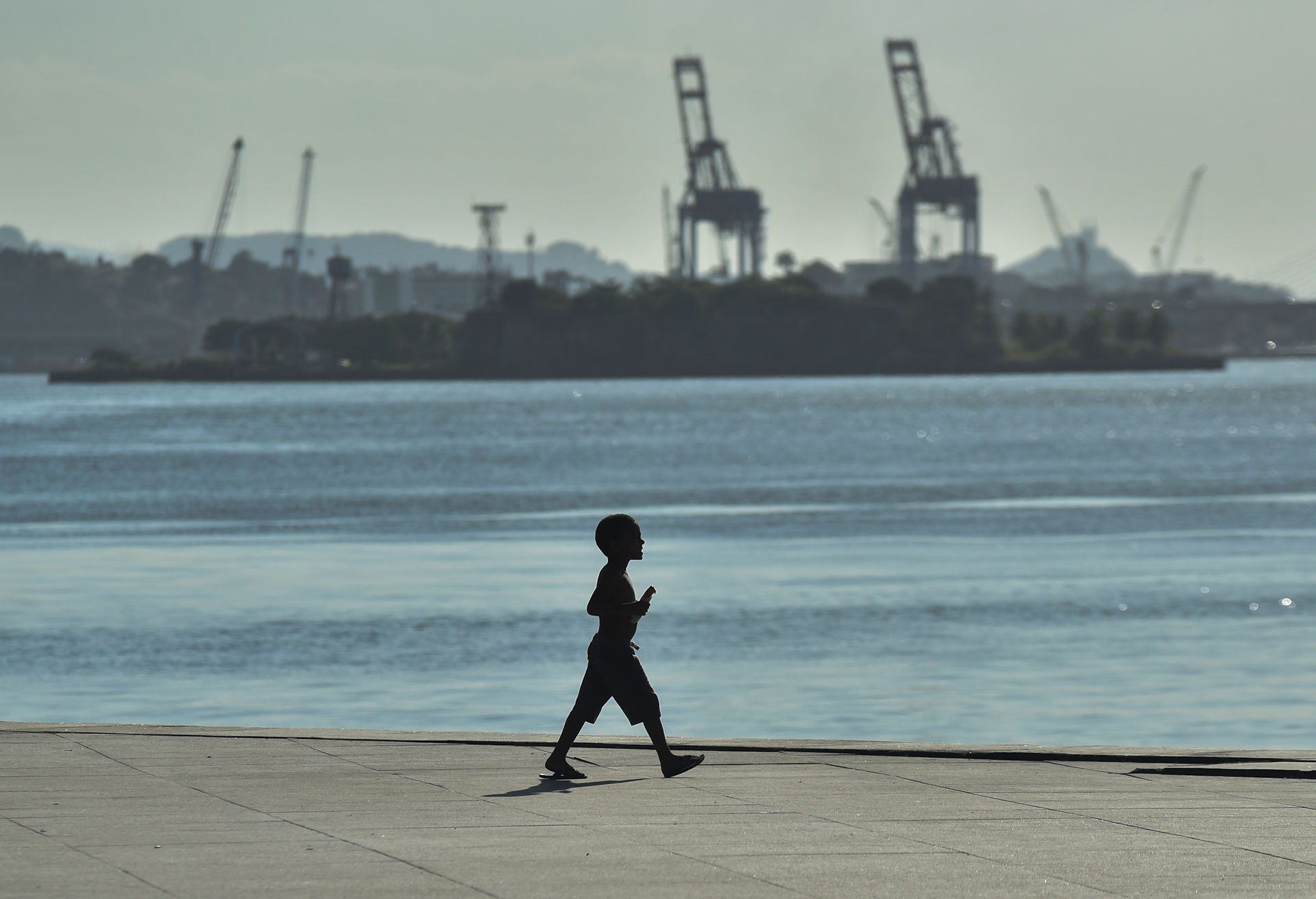 Children play and swim in the Guanabara Bay despite pollution
