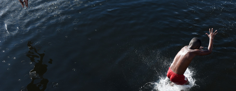 Children play and swim in the Guanabara Bay despite pollution