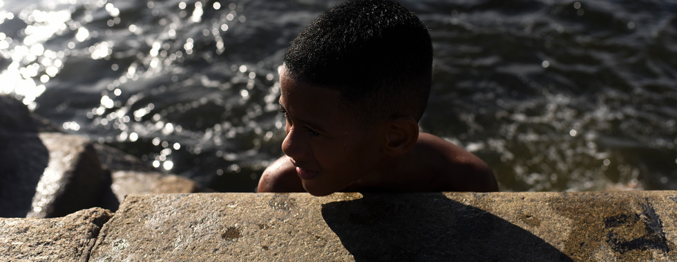 Children play and swim in the Guanabara Bay despite pollution