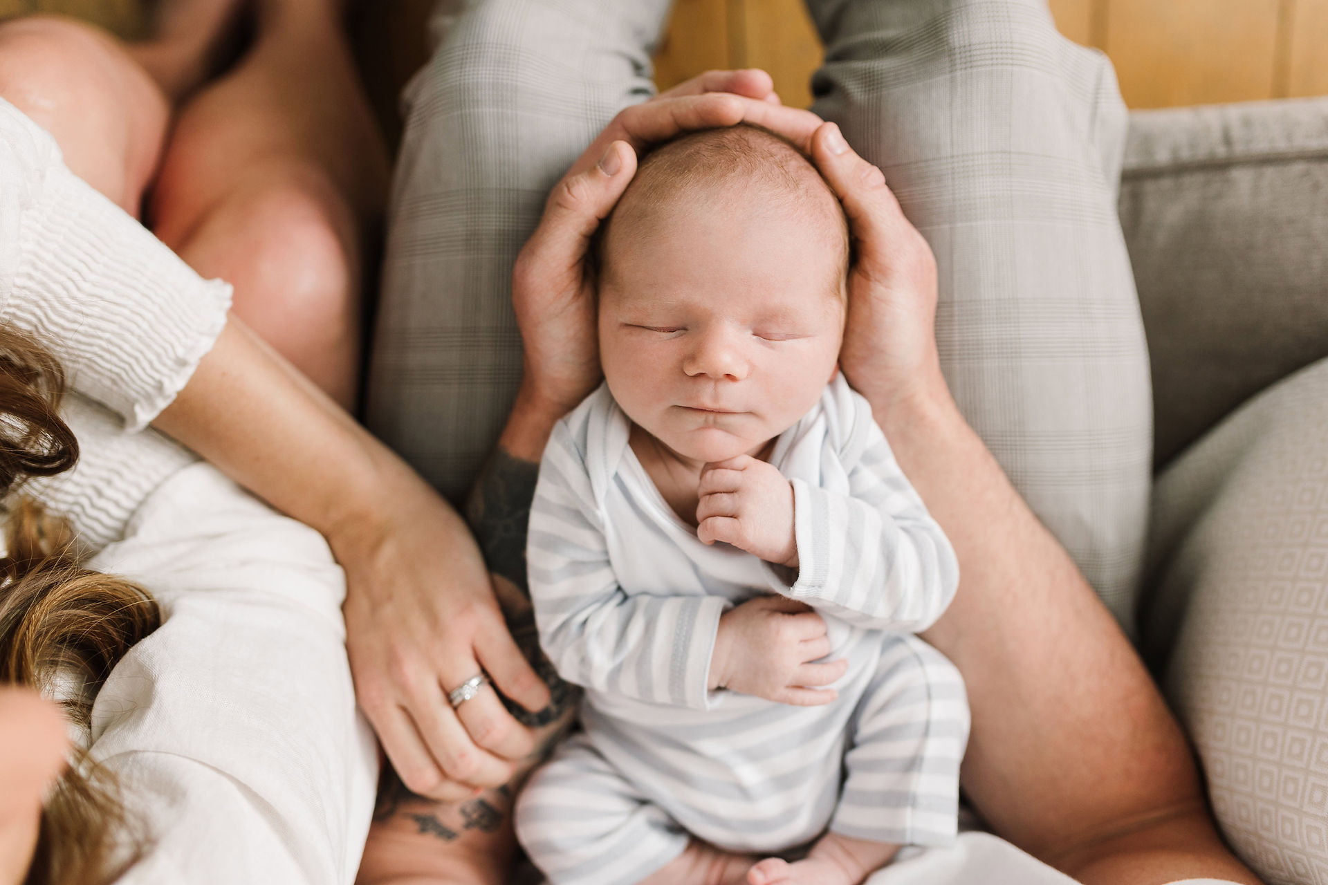 newborn baby in parents hands