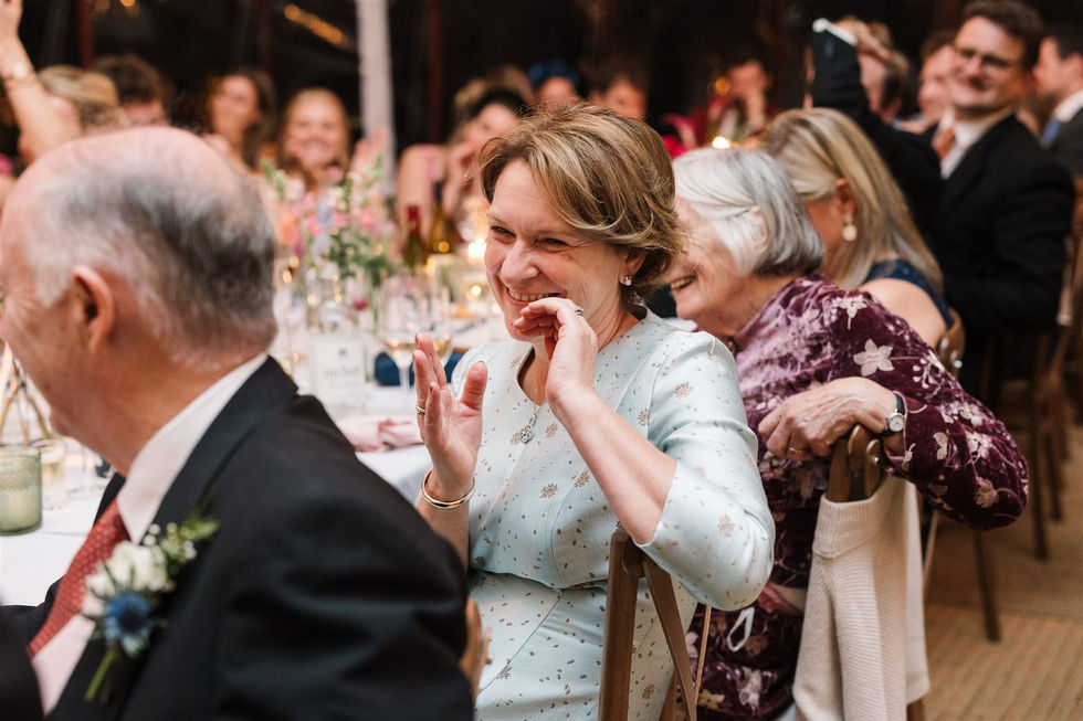mother of the bride laughing and clapping