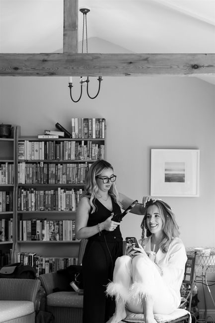 bride having her hair done on wedding day