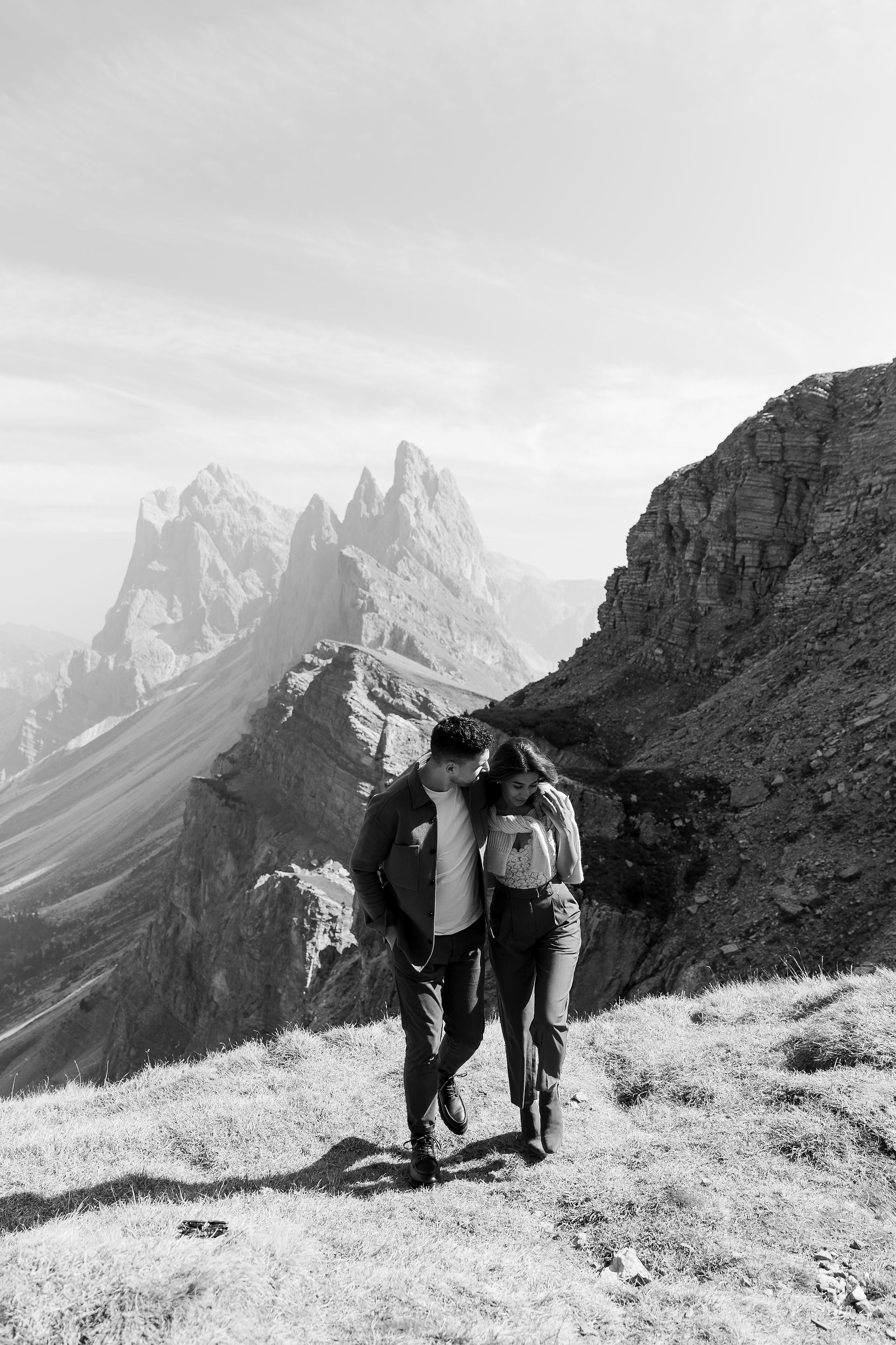 couple walking with mountains in background