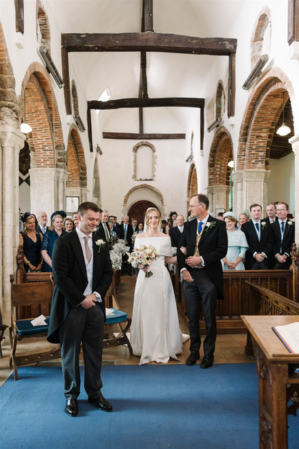 father walking daughter down aisle in church