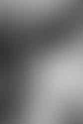 mother of the bride doing daughters dress on wedding day