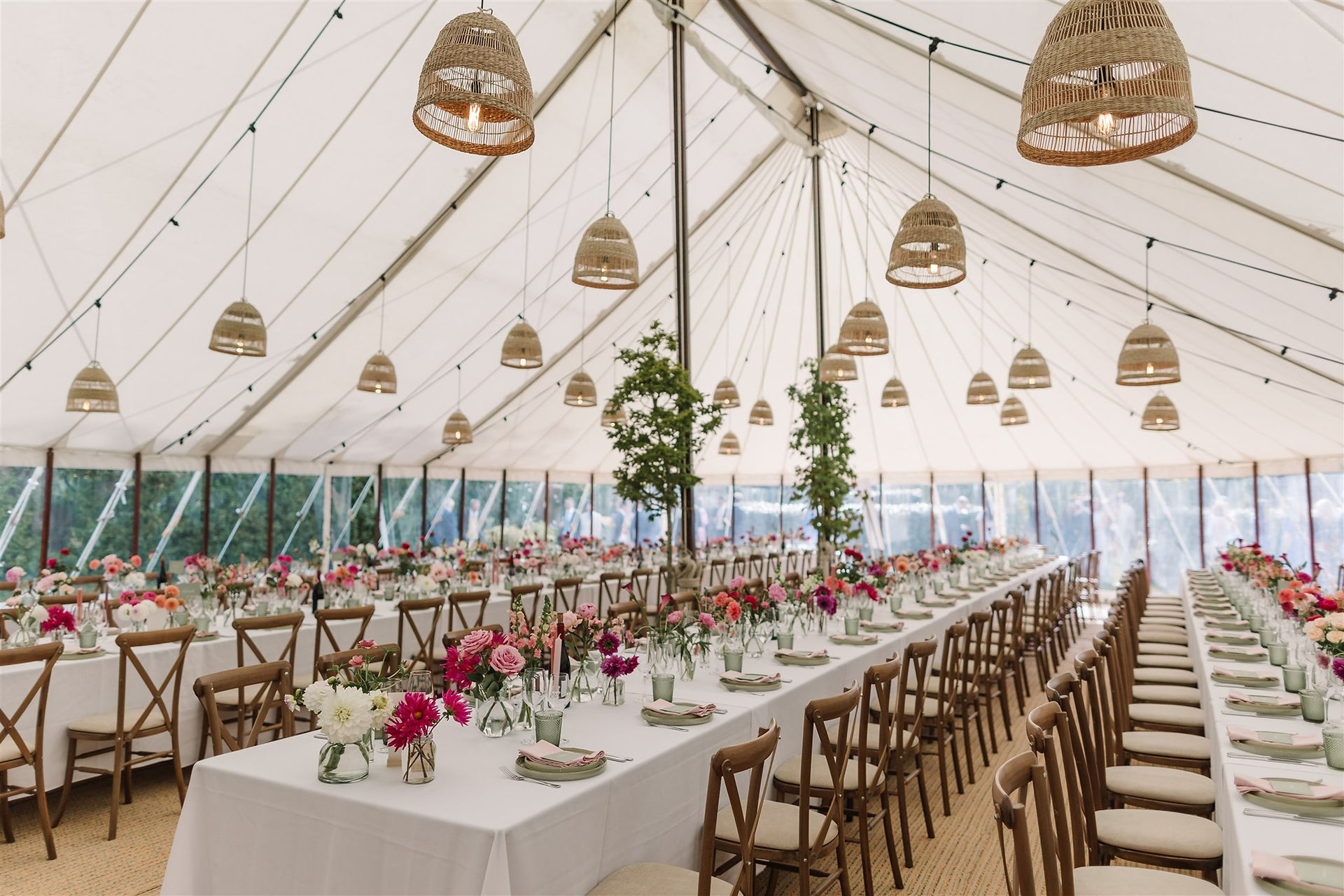 wedding marquee with pink flowers and rustic lights