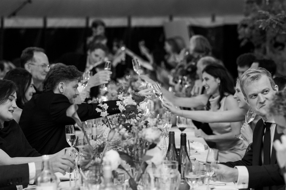 black and white photo of guests toasting drinks