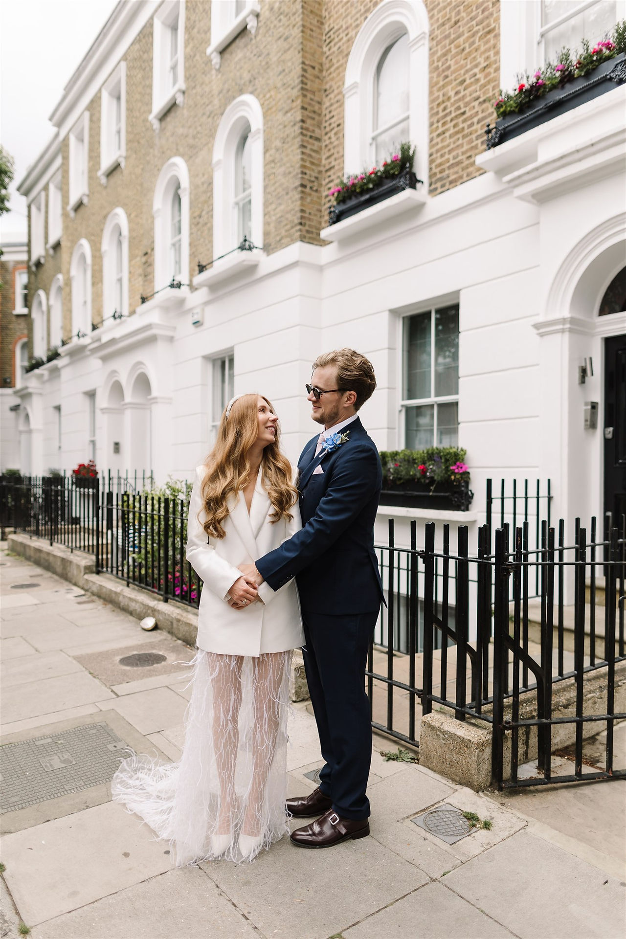 bride wearing chic blazer dress with her husband