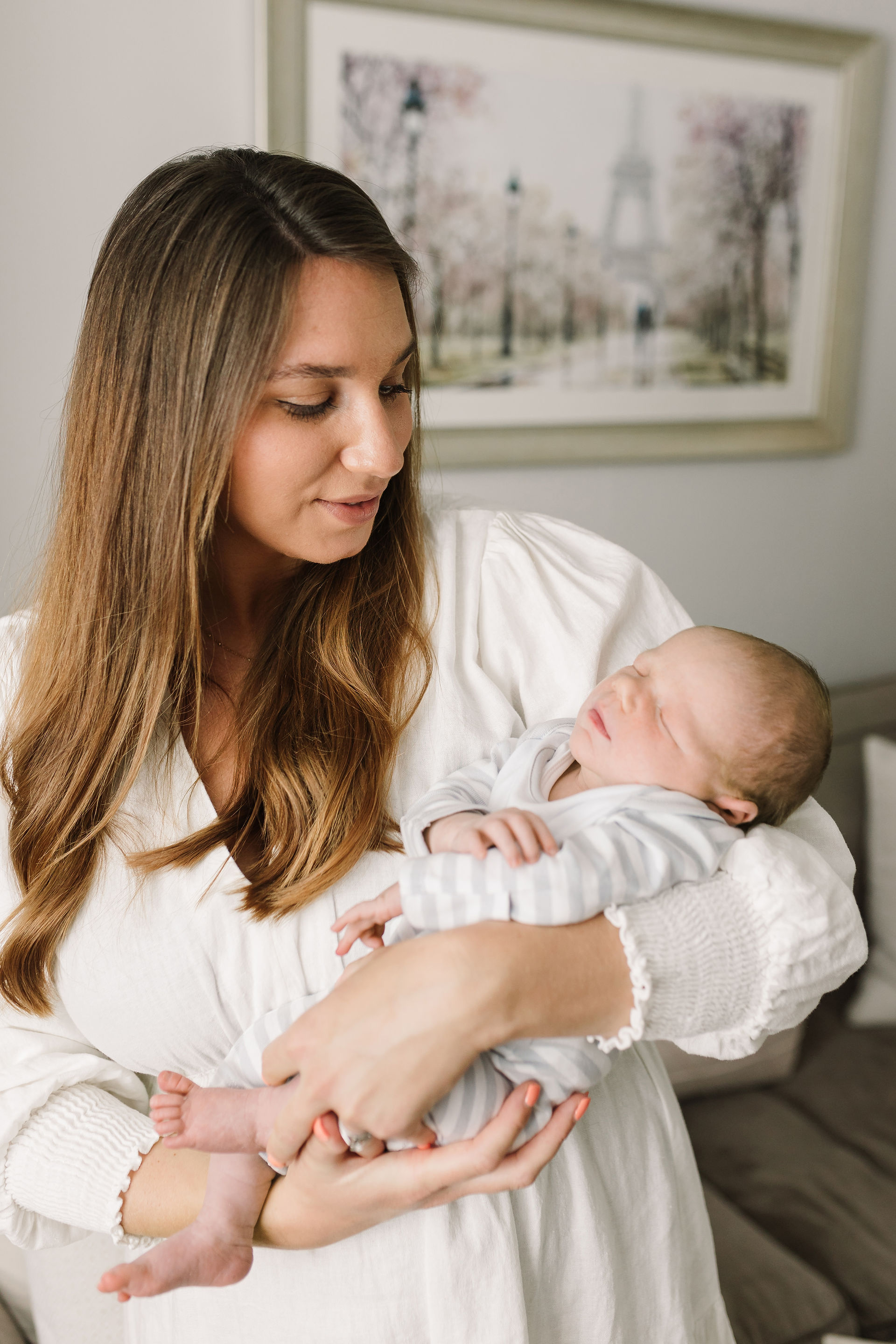 Mother holding newborn baby at home