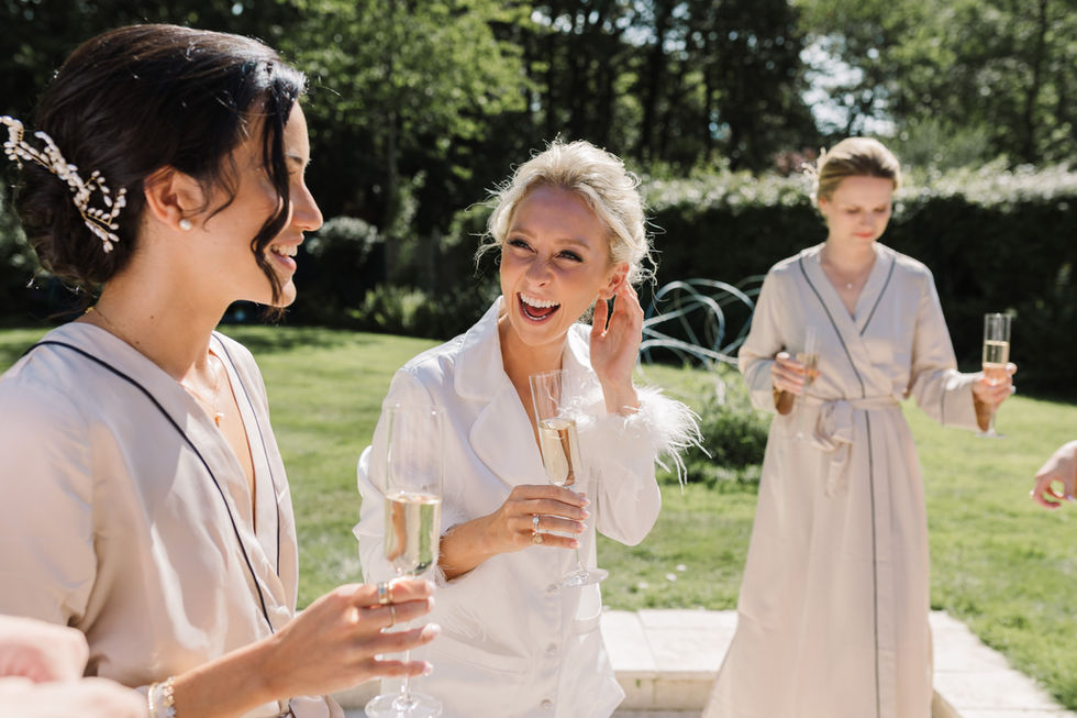 bride laughing with bridesmaids