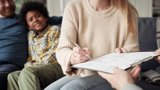 A mother signing a document | Parenting Plans | Sims & Purzer, Attorneys at Law, PLLC