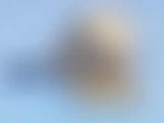 Close-up of a wooden house model under a magnifying glass with '2026' in the foreground, symbolising examining Reading’s future housing market.