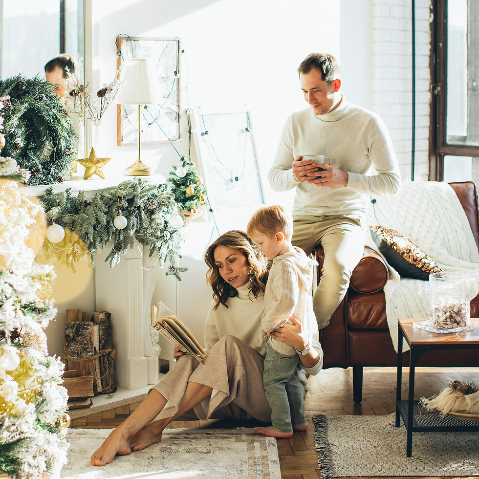 Mom seated on floor, reading to child while dad watches