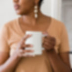A black woman holding a cup