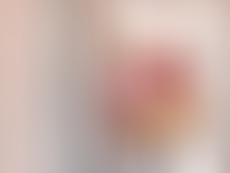 Senior couple smiling while carrying boxes into a bright home during a stress-free organizing or downsizing session.