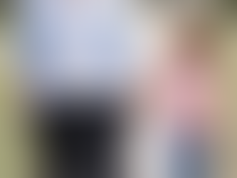 A woman, possibly experiencing lymphedema from hormonal changes, enjoys a walk with a young girl, both savoring a joyful and connected moment on a sunny day.