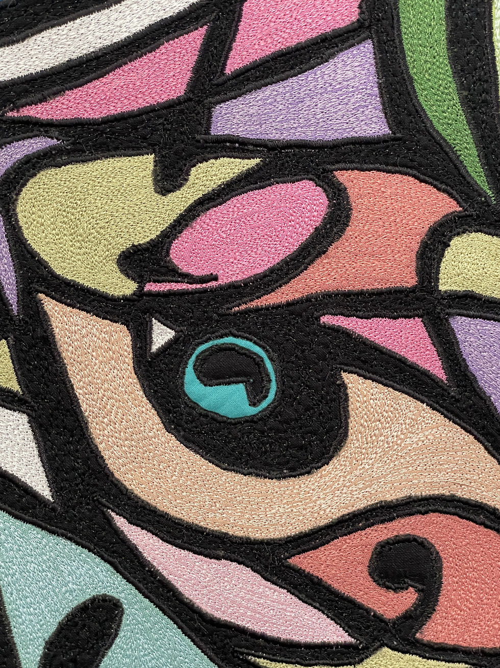 Colorful abstract embroidery with swirling patterns in pink, green, yellow, and black threads.