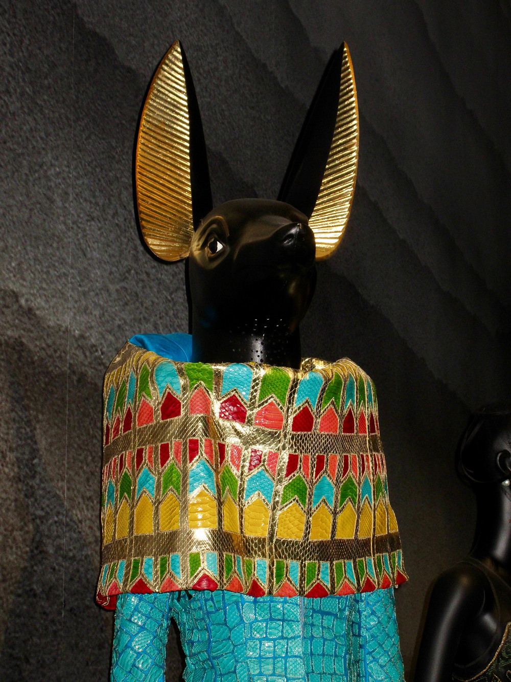 John Galliano Spring/Summer 2014 in Python Leather, modelled on the God Anubis using turquoise to symbolise the Nile. Headpiece by Stephen Jones.