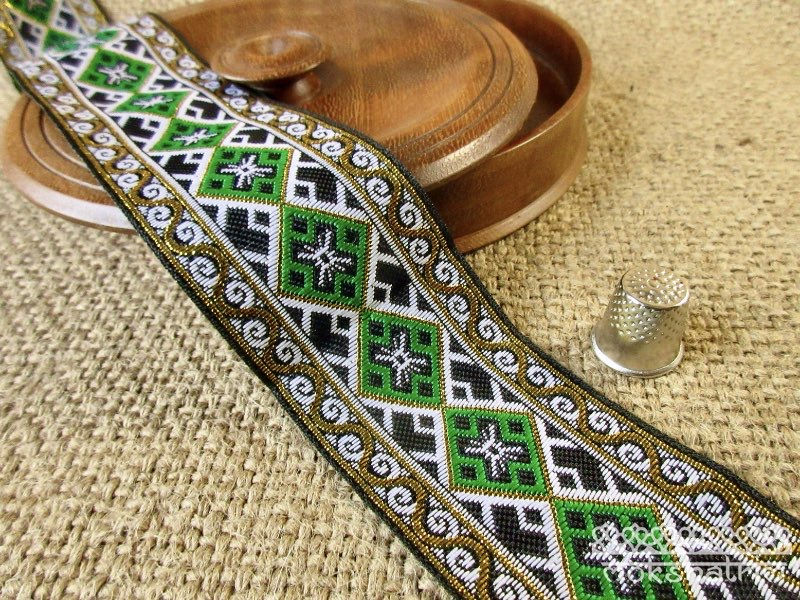 Thumbnail: 50 mm geometric jacquard ribbon with metallic gold thread in emerald green or royal blue colourways. Decorative woven trim.