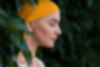 Young female cancer patient wearing headscarf closed eyes side view garden portrait. Menta