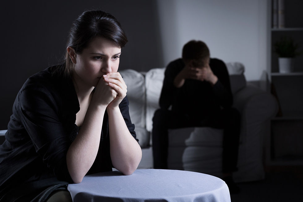 Divorcing couple sitting in darkness and silence