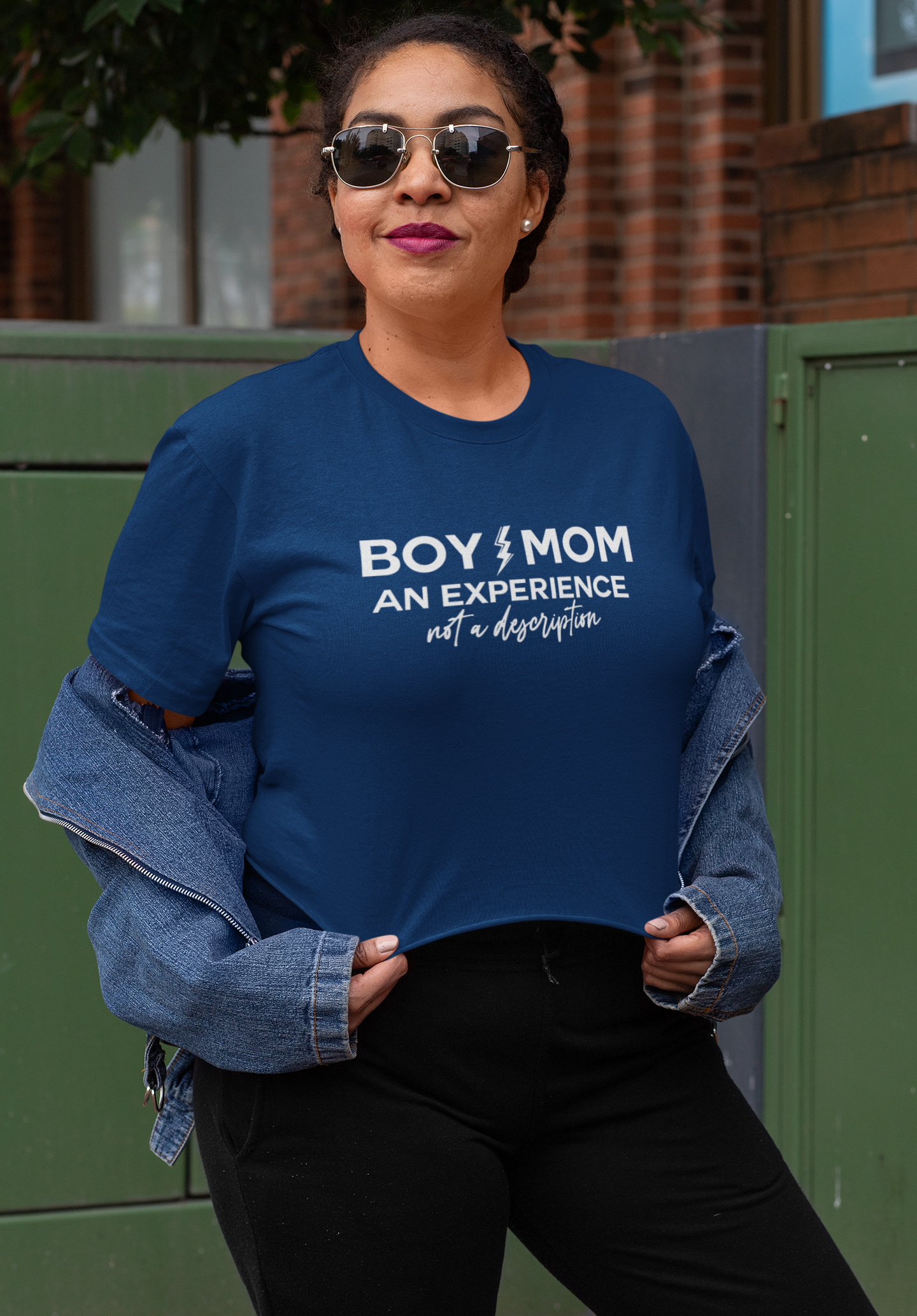 Mom wearing blue “Boy Mom An Experience Not a Description” t-shirt, sassy boy mom life shirt for moms of boys.