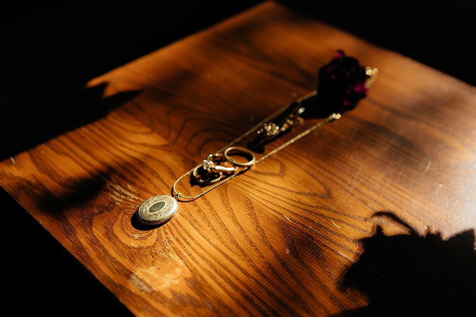 Eye-level view of heirloom brooch and vintage lace handkerchief arranged with wedding details