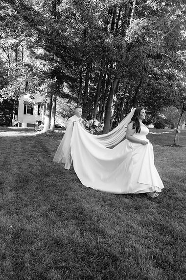 A virginia wedding photographer capturing the maid of honor assisting the bride to the nex
