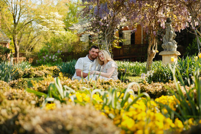 A couple surrounded by the spring blooms of the gardens at Chatham Manor, Fredericksburg Virginia