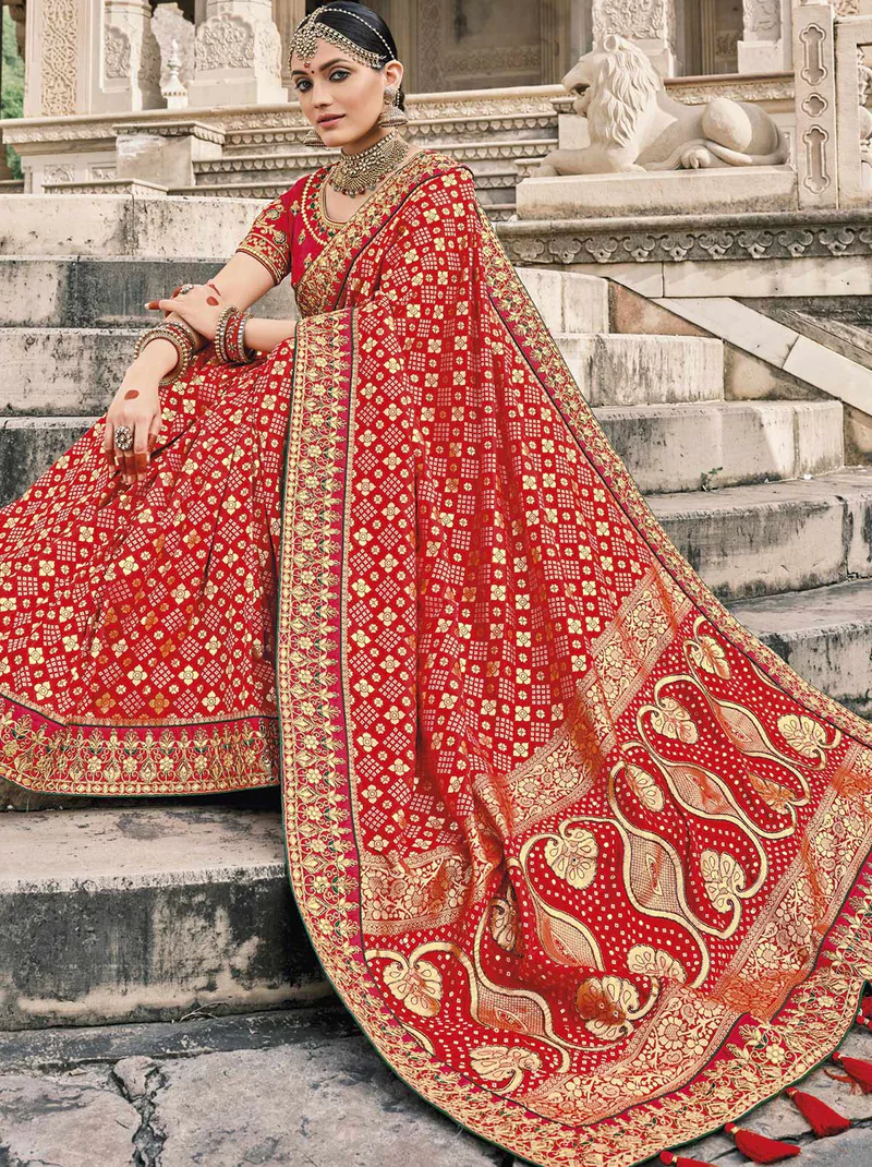 bride in red Bandhani Patola silk sarees for wedding