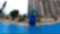 Wide angle view of a swimming pool with children participating in a fun water activity