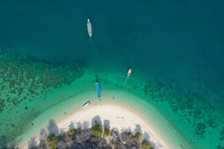 aerial-view-of-island-with-white-sand-and-boats-2022-02-01-22-38-51-utc