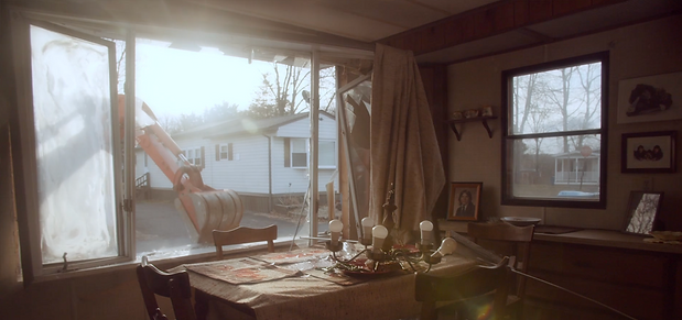 machine busting through wall.