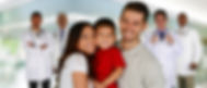 Smiling husband, wife, and child in front of a team of doctors
